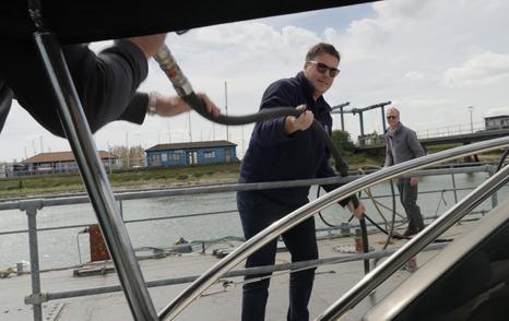  James Barke receiving a diesel fuel hose aboard the Princess V39 at the fuel pontoon during the Prop Gear challenge.