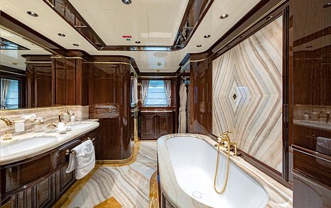 En-suite bathroom onboard Sanlorenzo Lady Lena, bath on starboard side with his and hers sinks port