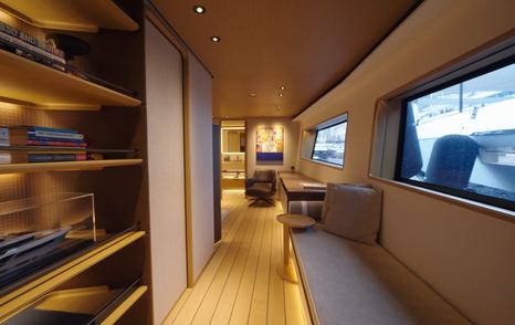 Custom Line Navetta 38 owner’s suite with side seating area, storage and long window bringing in natural light