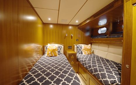 Nordhavn 75 EYF twin guest cabin with adult-sized single berths and built-in storage