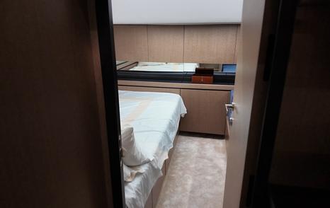 View into the amidships cabin of the Aiata Sunfinder 50 from the companionway, showing the berth and built-in storage.