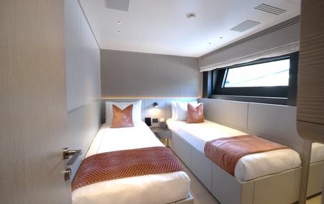 Benetti Oasis 34M twin guest cabin with hull-side window, twin berths and contemporary interior styling.