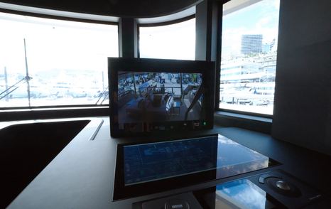 Custom Line Navetta 38 bridge screen showing camera view with side console and panoramic windows