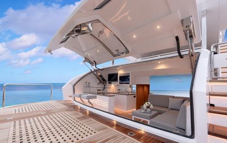 rendering of teak swim platform on the aft deck of the FD87 Skyline with door open revealing seating and bar area