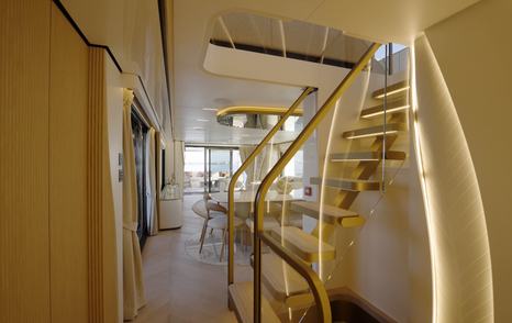 Open floating staircase connecting the main and lower decks on the Majesty 100 Terrace