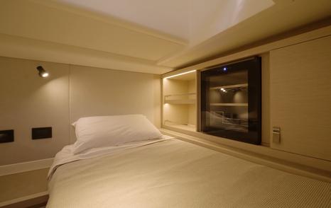 Pardo-43-Review-aft-twin-cabin-berth-with-wine-fridge-and-cabinetry