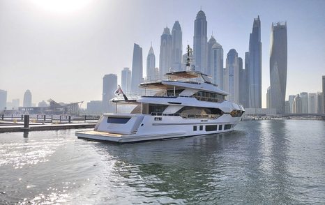 Aft view of Majesty 120 entering Dubai Harbour Marina, overlooking Dubai skyscrapers