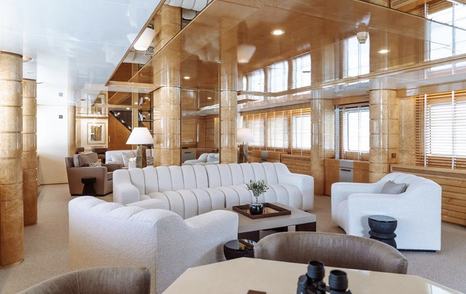 Feadship Superyacht Kassandra's main saloon with white sofas and marbled beige pillars