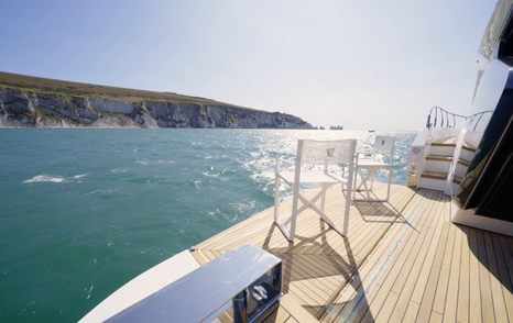 Fairline Targa 58 GTO starboard terrace with outdoor seating beside the cockpit