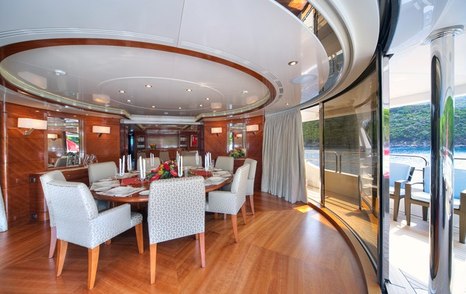 Superyacht Harmony III's main saloon circular dining area