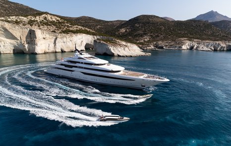 Two tenders and superyacht O'PARI with cliffs in background