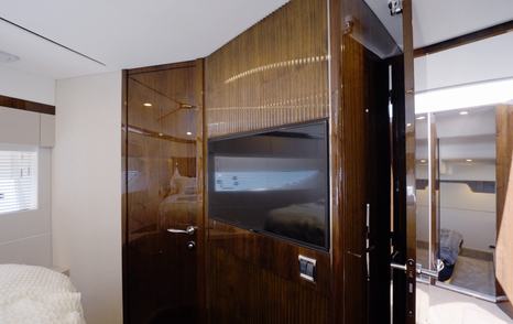 Television and wardrobe in the Fairline Targa 47 GT forward guest cabin