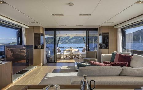 Superyacht Epic main saloon with L-shaped sofa and glass sliding doors
