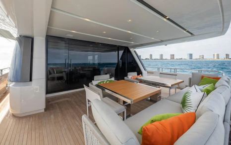 Motor yacht Xwave's aft deck alfresco dining and glass sliding doors