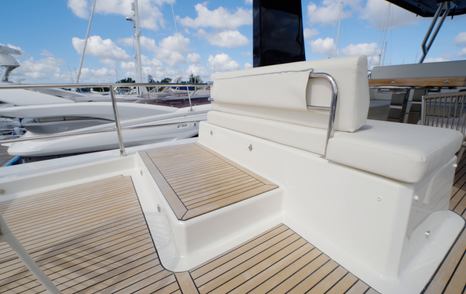 Beneteau Grand Trawler 63 flybridge sunpad with raised bench and teak side decks