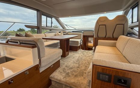 Main saloon on motor yacht F50 with helm station, lounge and dining area 
