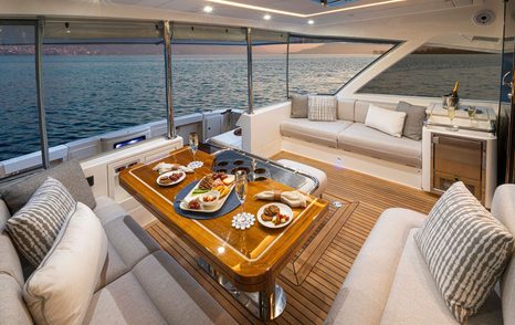 Riviera 645 SUV Series II motor yacht aft deck dining area 