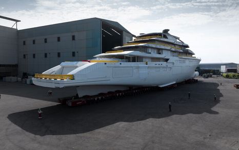 Aft view of Oceanco Project Y722 on tarmac outside construction shed