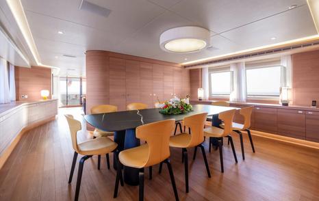 Expedition yacht Bijin main saloon dining area with yellow chairs