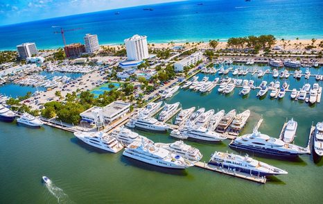 Aerial view of Lauderdale Marina – Fort Lauderdale. Many yachts moored, surrounded by sea.