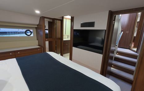 Maritimo M50 owner’s cabin showing TV, storage units and access steps