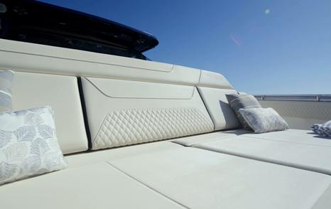 Aquila 45 Sport forward sunpad cushions with backrest detail, showing bow lounging area and upholstery finish