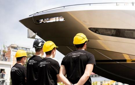 Workers looking at bow of Second 34m AB110 Motor Yacht at launch