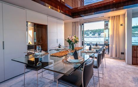 Superyacht Taku main saloon dining area glass table