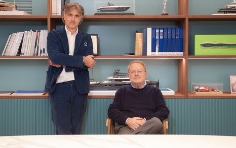 Landscape image of Simone Antonini and Fulvio De Simoni with bookshelves in background