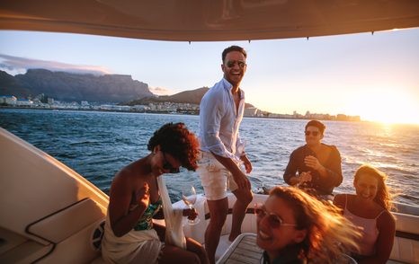 yacht owner and guests on aft deck sunset