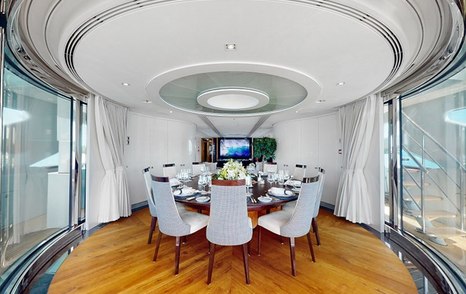 Superyacht After You's main saloon circular dining table and area