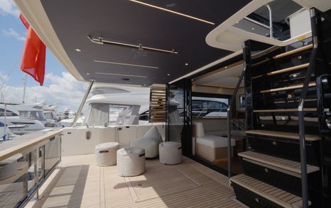 Beneteau Grand Trawler 63 aft cockpit showing wide flybridge staircase and sheltered outdoor living space