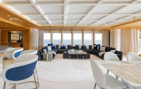 Superyacht Here Comes The Sun's main salon with panoramic windows