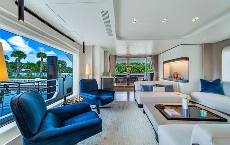 Superyacht One & Only main saloon with blue chairs and coffee table 