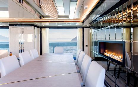 Salon with formal dining area and real fire on superyacht STEFANIA 