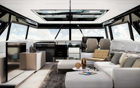 Overview of interior skylounge onboard Ferretti 1000 Skydeck. White sofas to starboard side with helm in background.