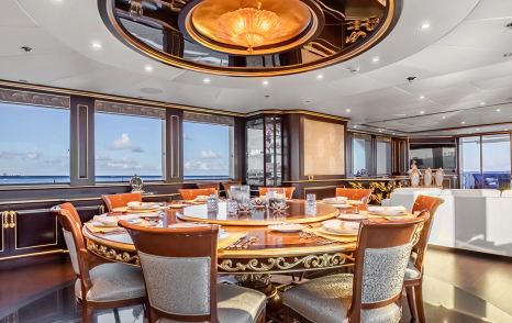 Superyacht Status Quo's main saloon with circular dining table