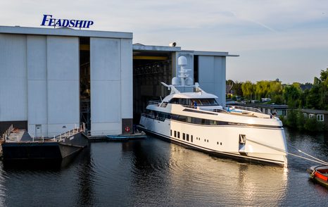 Feadship Project 706 superyacht being tugged out of construction facility