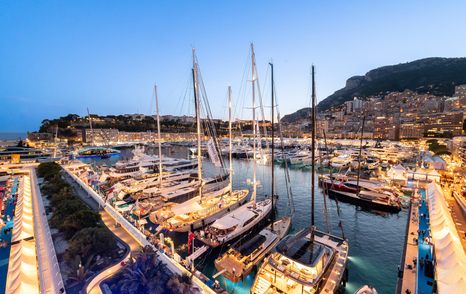 sailing yachts on display Monaco Yacht Show at dusk