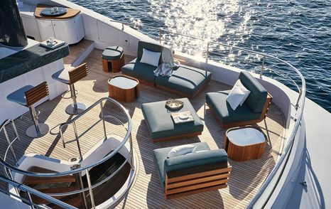 Exterior seating arrangement on Magellano 25 Metri flybridge, with wetbar to port side, overlooking the sea