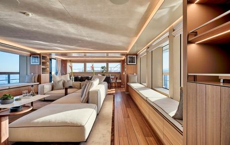 Superyacht Para Bellum main saloon L-shaped sofa and window seating 