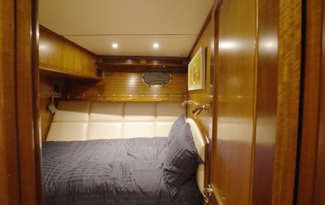 Nordhavn 75 EYF double guest cabin with tapered berth and handcrafted timber joinery