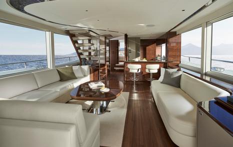 Princess X80 motor yacht saloon with white L-shaped sofa
