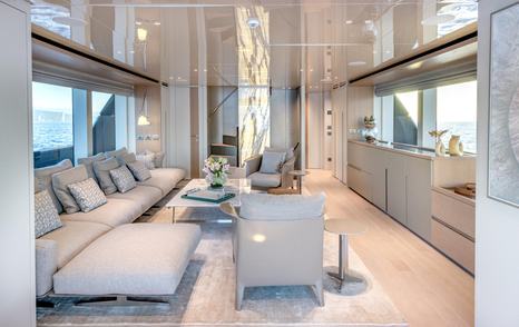 Motor yacht Speranza II's main saloon with staircase and L-shaped sofa