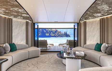 Rendering of Sirena 42M superyacht main saloon with curved white seating and glass sliding doors 