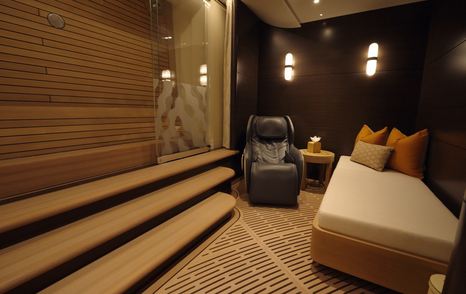 Spa relaxation area on the Amels 242 Casino Royale with seating and access to a drop-down sea terrace.