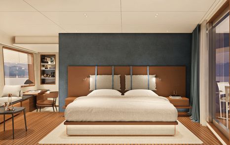 bed with white linen in master suite of Navetta 30 with full-length windows, teak floorboards and grey wall panels