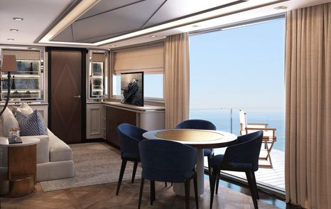 Rendering of interior of Bering 145, with table and chairs next to fold down balcony