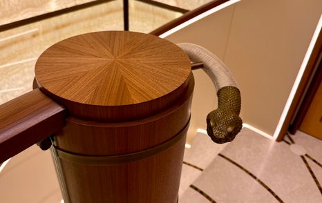 Decorative snake-shaped bannister detail on the staircase of the Amels 242 Casino Royale linking the yacht’s decks.