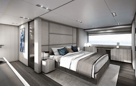 Owner's cabin onboard Ferretti 1000, central berth with wide window on far side and glimpse of en-suite behind berth.